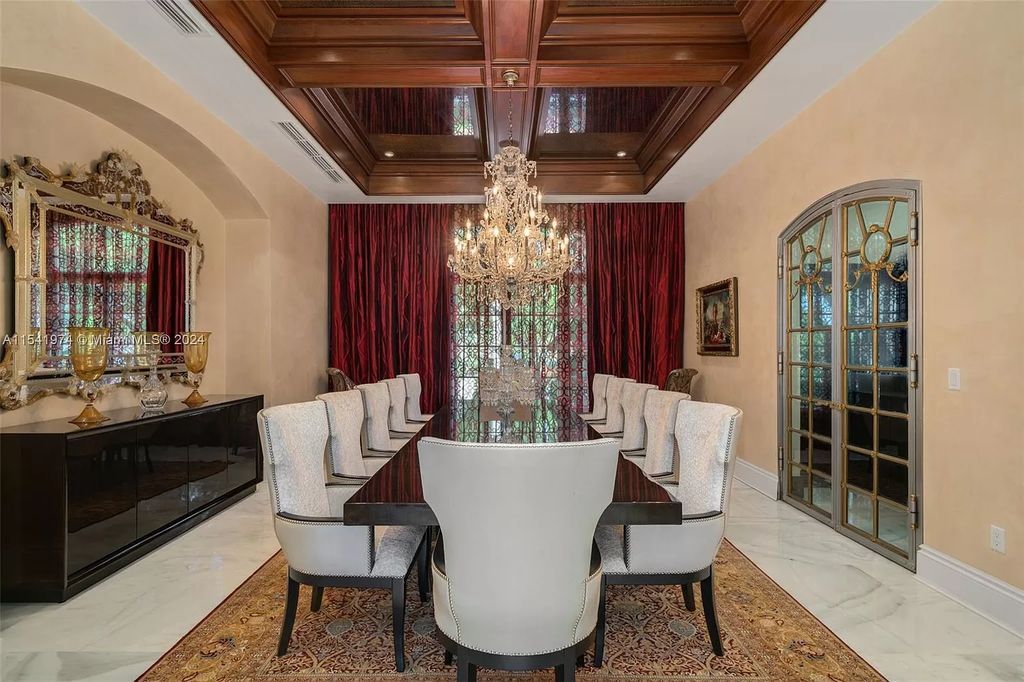 Nestled within the prestigious guard-gated community of Gables Estates, 33 Arvida Parkway presents a magnificent 14,972-square-foot estate boasting 225 feet of waterfront on a lushly landscaped 35,389-square-foot lot.