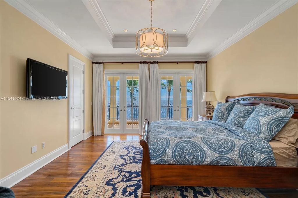 Nestled within the prestigious guard-gated community of Gables Estates, 33 Arvida Parkway presents a magnificent 14,972-square-foot estate boasting 225 feet of waterfront on a lushly landscaped 35,389-square-foot lot.