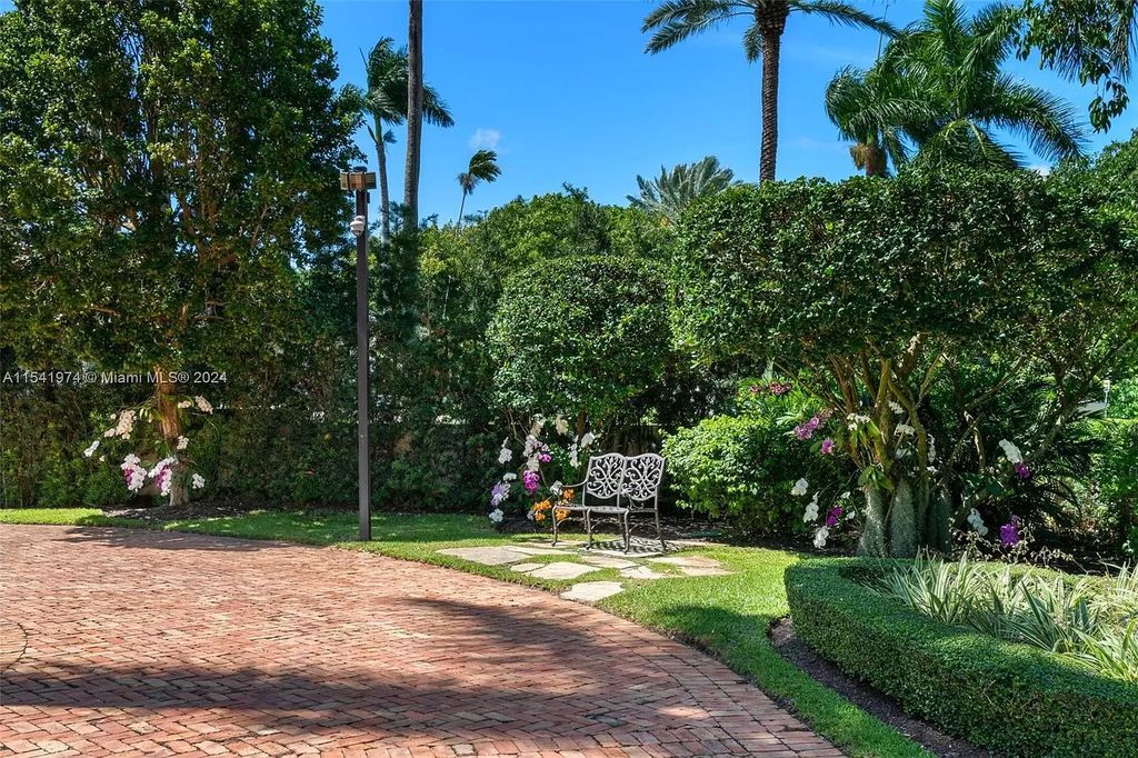 Nestled within the prestigious guard-gated community of Gables Estates, 33 Arvida Parkway presents a magnificent 14,972-square-foot estate boasting 225 feet of waterfront on a lushly landscaped 35,389-square-foot lot.