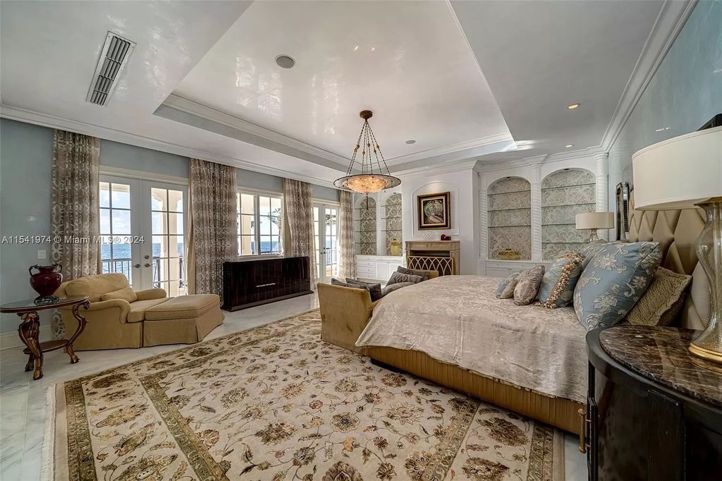 Nestled within the prestigious guard-gated community of Gables Estates, 33 Arvida Parkway presents a magnificent 14,972-square-foot estate boasting 225 feet of waterfront on a lushly landscaped 35,389-square-foot lot.