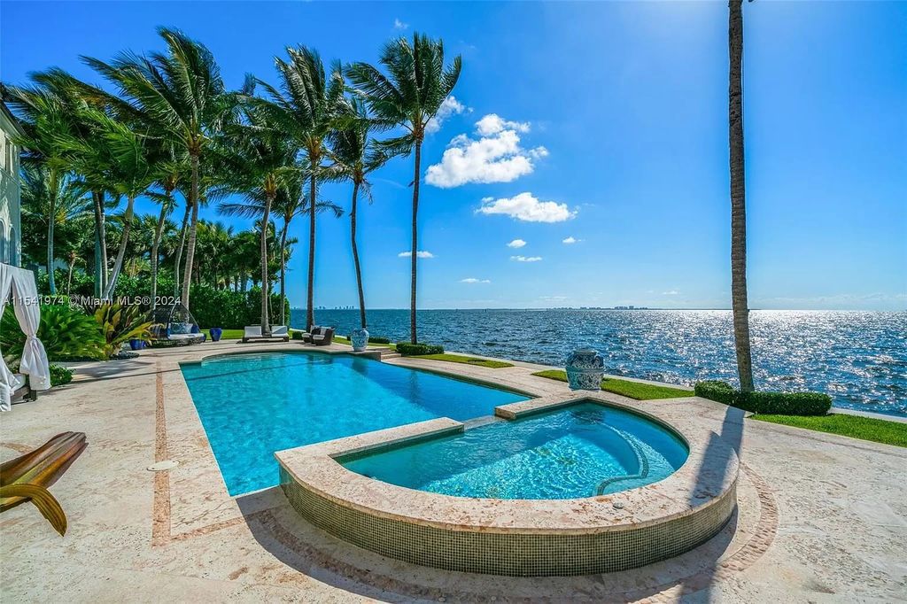 Nestled within the prestigious guard-gated community of Gables Estates, 33 Arvida Parkway presents a magnificent 14,972-square-foot estate boasting 225 feet of waterfront on a lushly landscaped 35,389-square-foot lot.