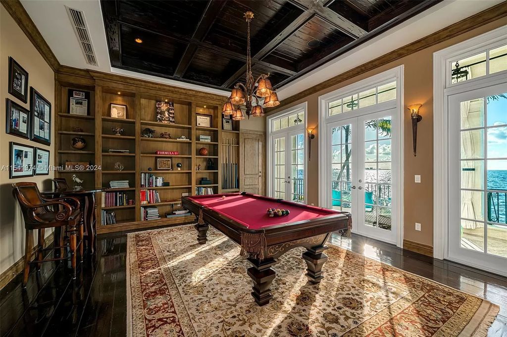 Nestled within the prestigious guard-gated community of Gables Estates, 33 Arvida Parkway presents a magnificent 14,972-square-foot estate boasting 225 feet of waterfront on a lushly landscaped 35,389-square-foot lot.
