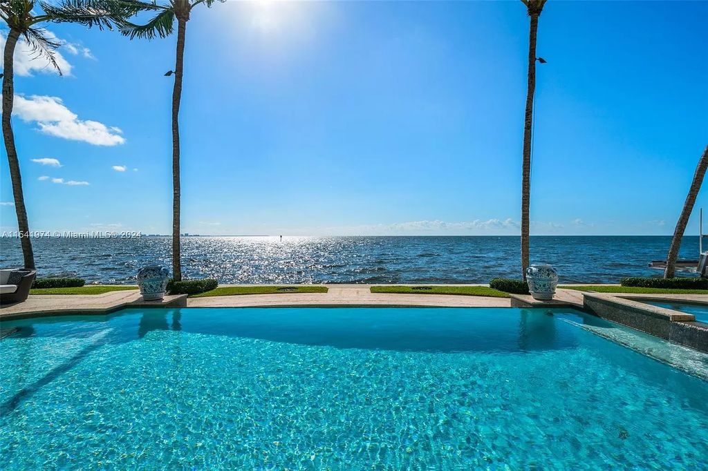 Nestled within the prestigious guard-gated community of Gables Estates, 33 Arvida Parkway presents a magnificent 14,972-square-foot estate boasting 225 feet of waterfront on a lushly landscaped 35,389-square-foot lot.