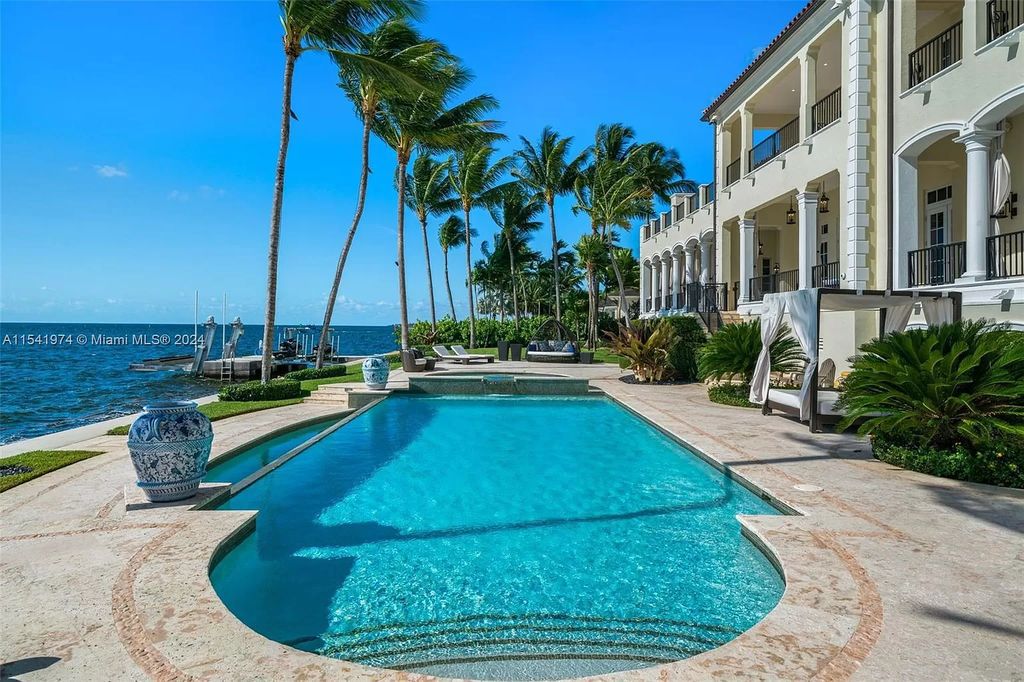 Nestled within the prestigious guard-gated community of Gables Estates, 33 Arvida Parkway presents a magnificent 14,972-square-foot estate boasting 225 feet of waterfront on a lushly landscaped 35,389-square-foot lot.