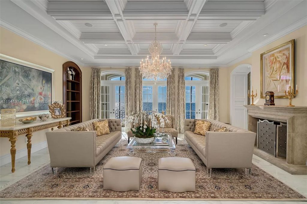 Nestled within the prestigious guard-gated community of Gables Estates, 33 Arvida Parkway presents a magnificent 14,972-square-foot estate boasting 225 feet of waterfront on a lushly landscaped 35,389-square-foot lot.