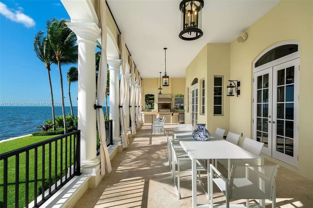 Nestled within the prestigious guard-gated community of Gables Estates, 33 Arvida Parkway presents a magnificent 14,972-square-foot estate boasting 225 feet of waterfront on a lushly landscaped 35,389-square-foot lot.
