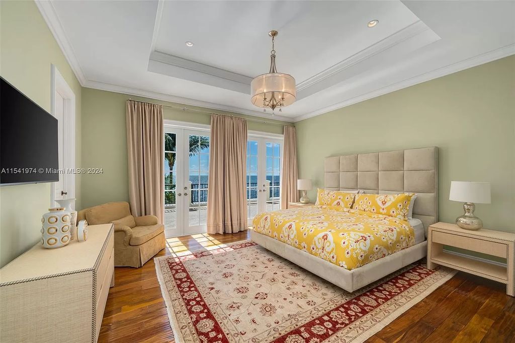 Nestled within the prestigious guard-gated community of Gables Estates, 33 Arvida Parkway presents a magnificent 14,972-square-foot estate boasting 225 feet of waterfront on a lushly landscaped 35,389-square-foot lot.