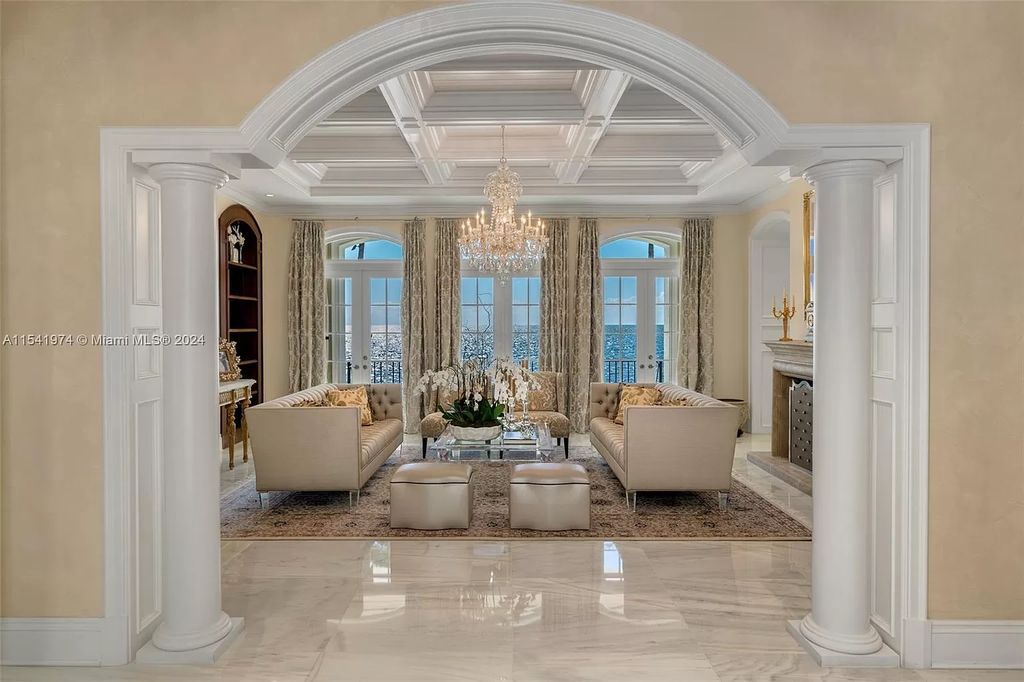 Nestled within the prestigious guard-gated community of Gables Estates, 33 Arvida Parkway presents a magnificent 14,972-square-foot estate boasting 225 feet of waterfront on a lushly landscaped 35,389-square-foot lot.