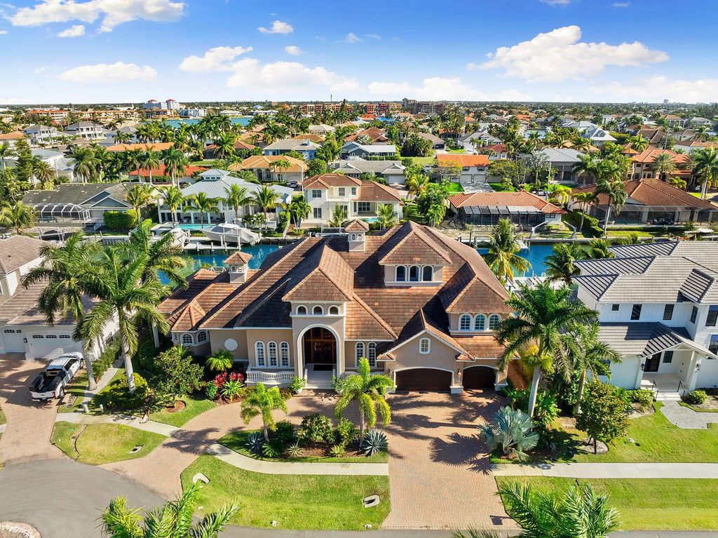 Experience unparalleled luxury living at this waterfront estate in Tigertail/Collier Bay, Marco Island. Boasting over $400,000 in price reduction, this multi-level home features a private elevator, 6 bedrooms, 7 bathrooms, 2 living rooms, a den, and a formal dining room, spanning just over 6,500 square feet of living space.