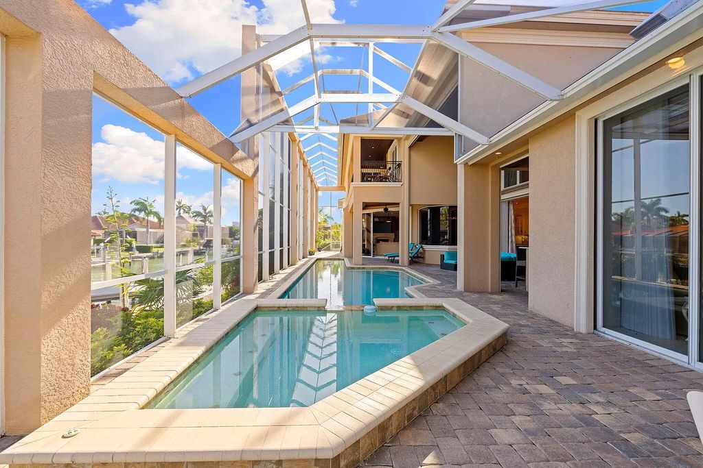 Experience unparalleled luxury living at this waterfront estate in Tigertail/Collier Bay, Marco Island. Boasting over $400,000 in price reduction, this multi-level home features a private elevator, 6 bedrooms, 7 bathrooms, 2 living rooms, a den, and a formal dining room, spanning just over 6,500 square feet of living space.