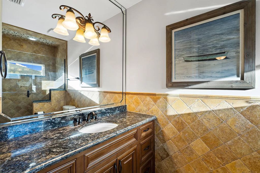 Experience unparalleled luxury living at this waterfront estate in Tigertail/Collier Bay, Marco Island. Boasting over $400,000 in price reduction, this multi-level home features a private elevator, 6 bedrooms, 7 bathrooms, 2 living rooms, a den, and a formal dining room, spanning just over 6,500 square feet of living space.