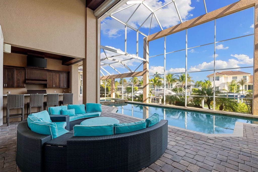 Experience unparalleled luxury living at this waterfront estate in Tigertail/Collier Bay, Marco Island. Boasting over $400,000 in price reduction, this multi-level home features a private elevator, 6 bedrooms, 7 bathrooms, 2 living rooms, a den, and a formal dining room, spanning just over 6,500 square feet of living space.