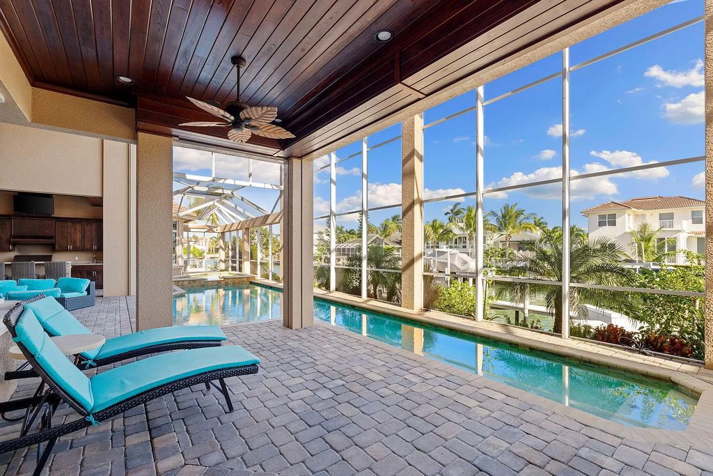 Experience unparalleled luxury living at this waterfront estate in Tigertail/Collier Bay, Marco Island. Boasting over $400,000 in price reduction, this multi-level home features a private elevator, 6 bedrooms, 7 bathrooms, 2 living rooms, a den, and a formal dining room, spanning just over 6,500 square feet of living space.