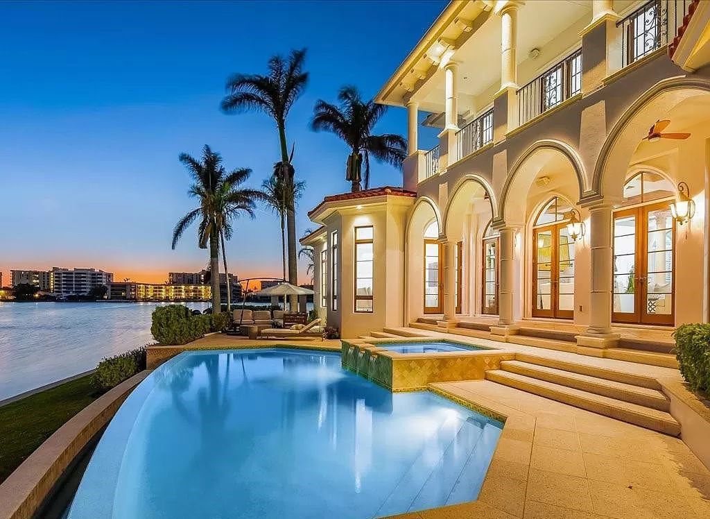Indulge in the epitome of luxury waterfront living at this magnificent Naples estate on 210 Cuddy Ct. Crafted by Kurtz Homes, this opulent residence boasts grand columns, exquisite tile flooring, and coffered ceilings, flooded with natural light.