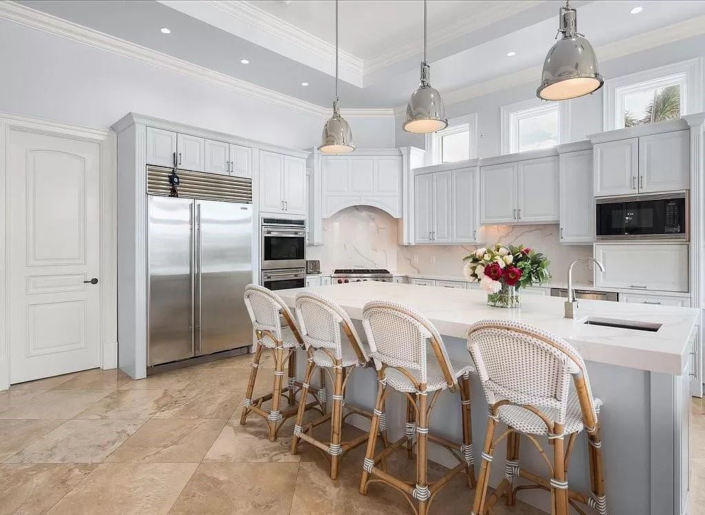 Indulge in the epitome of luxury waterfront living at this magnificent Naples estate on 210 Cuddy Ct. Crafted by Kurtz Homes, this opulent residence boasts grand columns, exquisite tile flooring, and coffered ceilings, flooded with natural light.