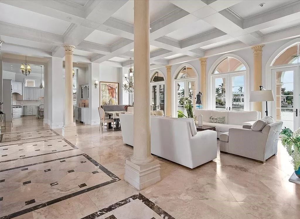 Indulge in the epitome of luxury waterfront living at this magnificent Naples estate on 210 Cuddy Ct. Crafted by Kurtz Homes, this opulent residence boasts grand columns, exquisite tile flooring, and coffered ceilings, flooded with natural light.