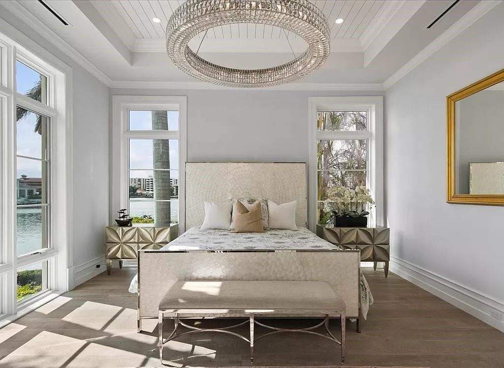 Indulge in the epitome of luxury waterfront living at this magnificent Naples estate on 210 Cuddy Ct. Crafted by Kurtz Homes, this opulent residence boasts grand columns, exquisite tile flooring, and coffered ceilings, flooded with natural light.