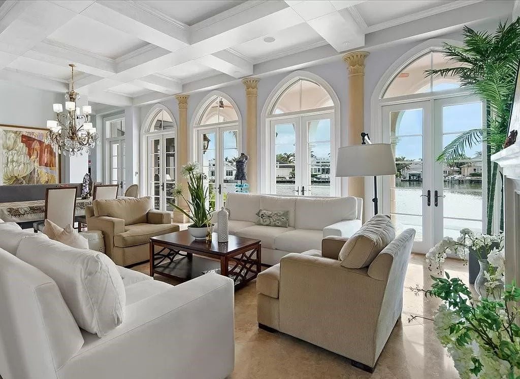 Indulge in the epitome of luxury waterfront living at this magnificent Naples estate on 210 Cuddy Ct. Crafted by Kurtz Homes, this opulent residence boasts grand columns, exquisite tile flooring, and coffered ceilings, flooded with natural light.
