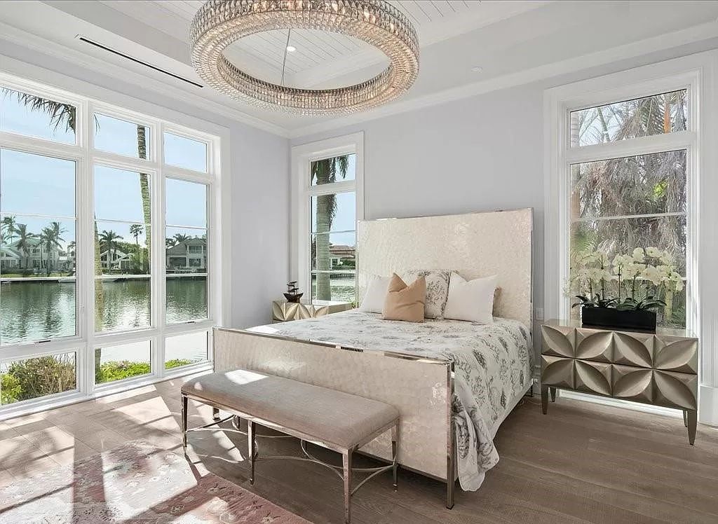 Indulge in the epitome of luxury waterfront living at this magnificent Naples estate on 210 Cuddy Ct. Crafted by Kurtz Homes, this opulent residence boasts grand columns, exquisite tile flooring, and coffered ceilings, flooded with natural light.