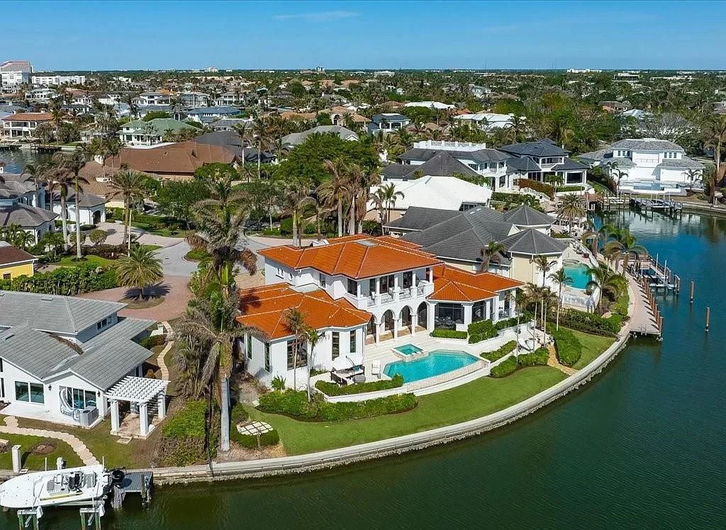 Indulge in the epitome of luxury waterfront living at this magnificent Naples estate on 210 Cuddy Ct. Crafted by Kurtz Homes, this opulent residence boasts grand columns, exquisite tile flooring, and coffered ceilings, flooded with natural light.