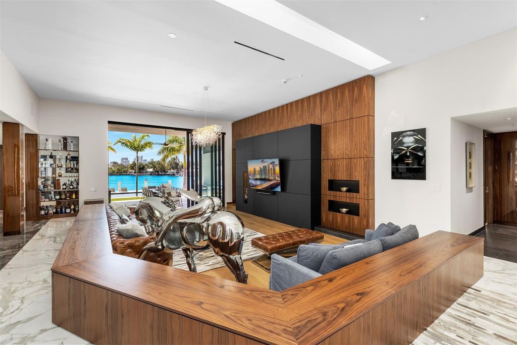 Rebuilt in July 2023, this single-story smart home offers 5,073 square feet of sophisticated living space on a sprawling 15,300-square-foot lot with a 2,300-square-foot dock adorned with coral stone from Spain.
