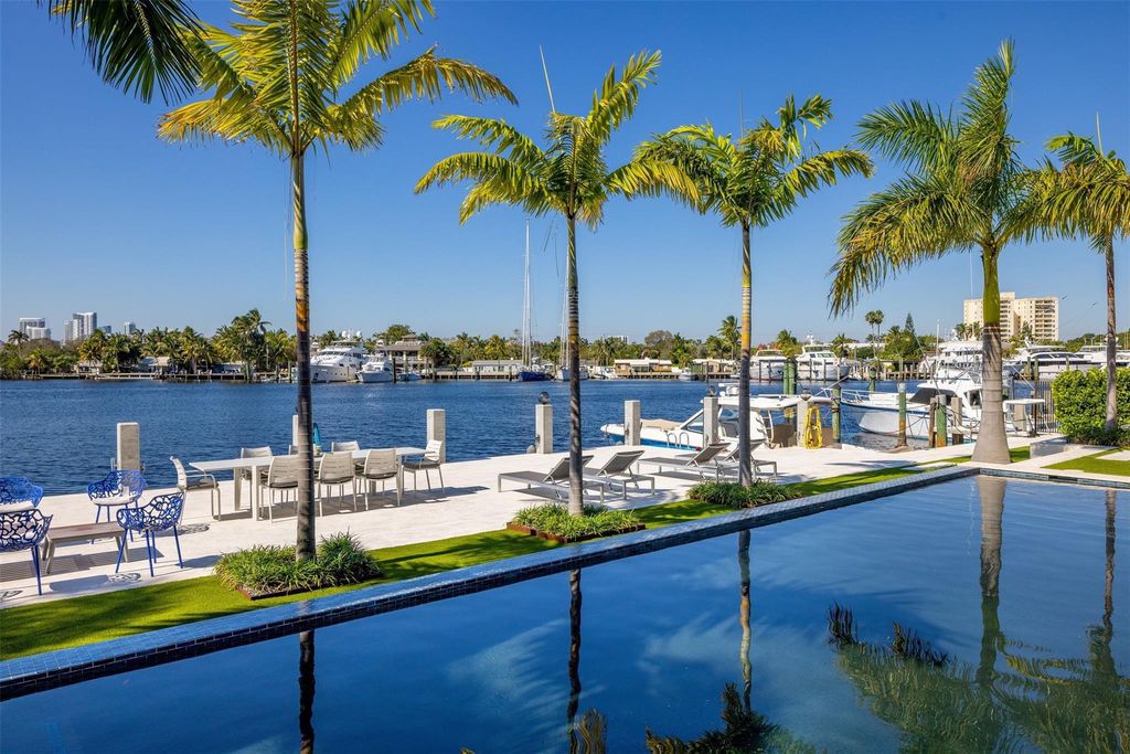 Rebuilt in July 2023, this single-story smart home offers 5,073 square feet of sophisticated living space on a sprawling 15,300-square-foot lot with a 2,300-square-foot dock adorned with coral stone from Spain.