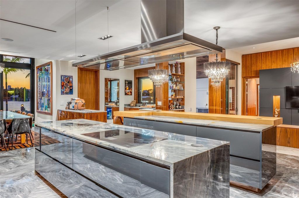 Rebuilt in July 2023, this single-story smart home offers 5,073 square feet of sophisticated living space on a sprawling 15,300-square-foot lot with a 2,300-square-foot dock adorned with coral stone from Spain.