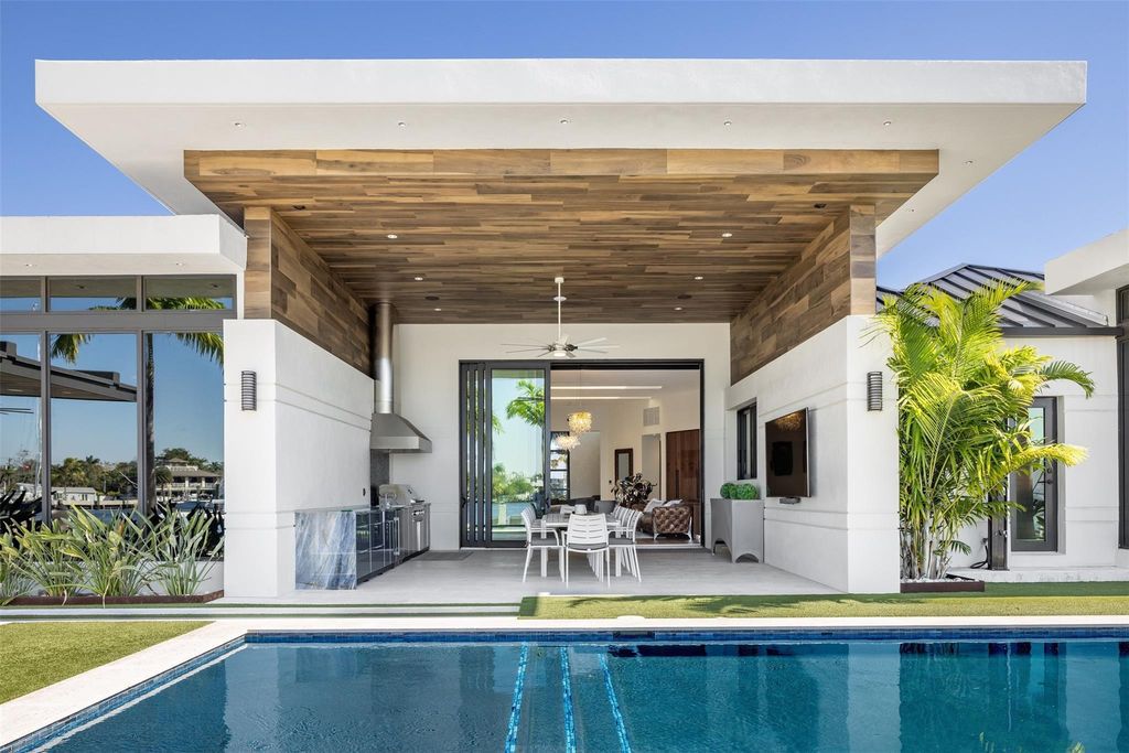 Rebuilt in July 2023, this single-story smart home offers 5,073 square feet of sophisticated living space on a sprawling 15,300-square-foot lot with a 2,300-square-foot dock adorned with coral stone from Spain.