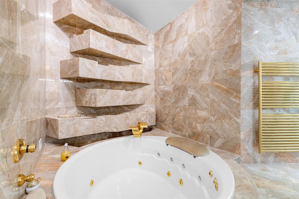 Rebuilt in July 2023, this single-story smart home offers 5,073 square feet of sophisticated living space on a sprawling 15,300-square-foot lot with a 2,300-square-foot dock adorned with coral stone from Spain.