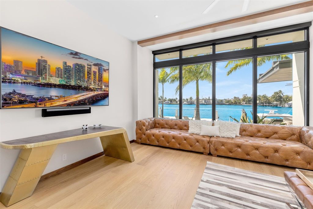 Rebuilt in July 2023, this single-story smart home offers 5,073 square feet of sophisticated living space on a sprawling 15,300-square-foot lot with a 2,300-square-foot dock adorned with coral stone from Spain.