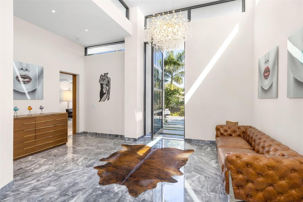 Rebuilt in July 2023, this single-story smart home offers 5,073 square feet of sophisticated living space on a sprawling 15,300-square-foot lot with a 2,300-square-foot dock adorned with coral stone from Spain.