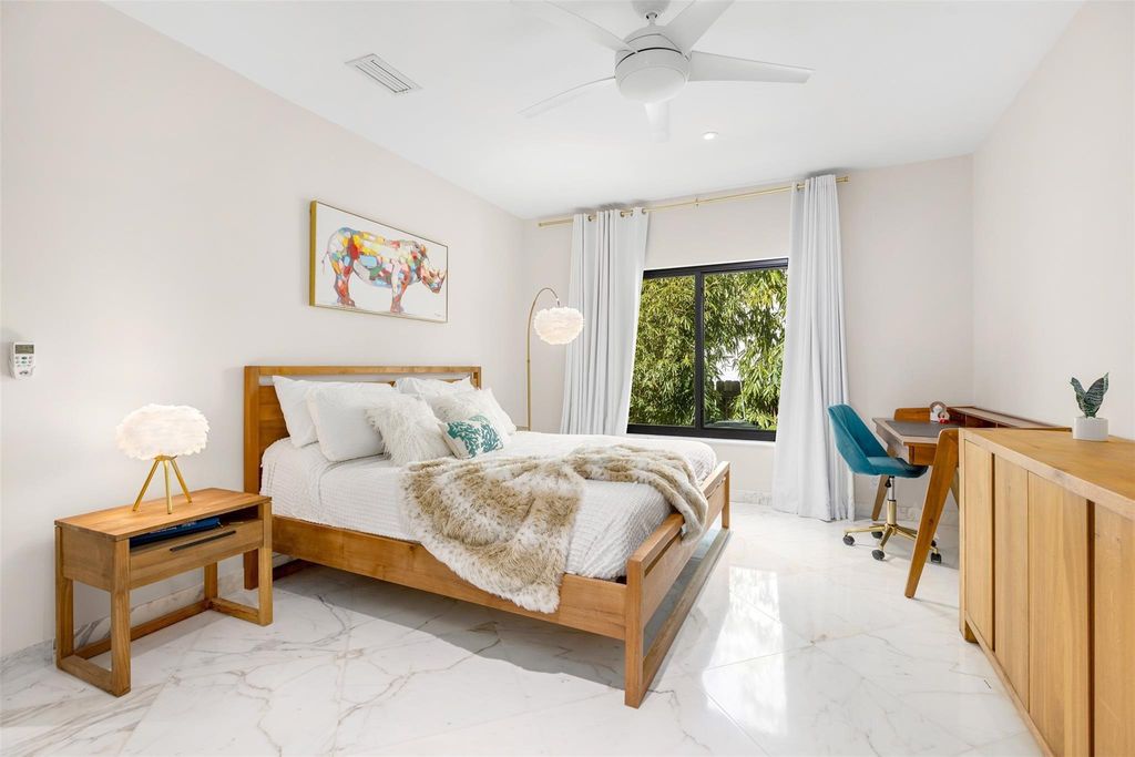 Rebuilt in July 2023, this single-story smart home offers 5,073 square feet of sophisticated living space on a sprawling 15,300-square-foot lot with a 2,300-square-foot dock adorned with coral stone from Spain.
