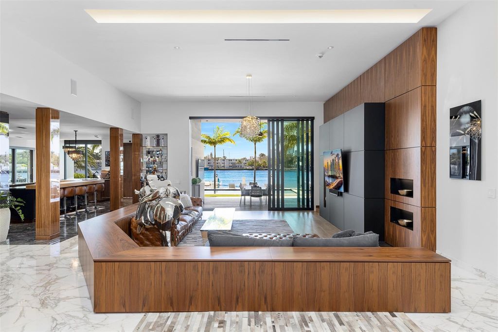 Rebuilt in July 2023, this single-story smart home offers 5,073 square feet of sophisticated living space on a sprawling 15,300-square-foot lot with a 2,300-square-foot dock adorned with coral stone from Spain.