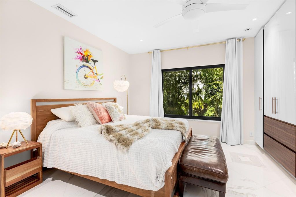 Rebuilt in July 2023, this single-story smart home offers 5,073 square feet of sophisticated living space on a sprawling 15,300-square-foot lot with a 2,300-square-foot dock adorned with coral stone from Spain.