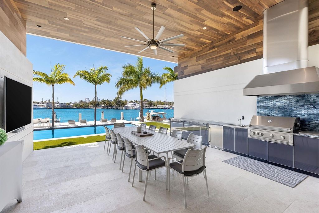 Rebuilt in July 2023, this single-story smart home offers 5,073 square feet of sophisticated living space on a sprawling 15,300-square-foot lot with a 2,300-square-foot dock adorned with coral stone from Spain.