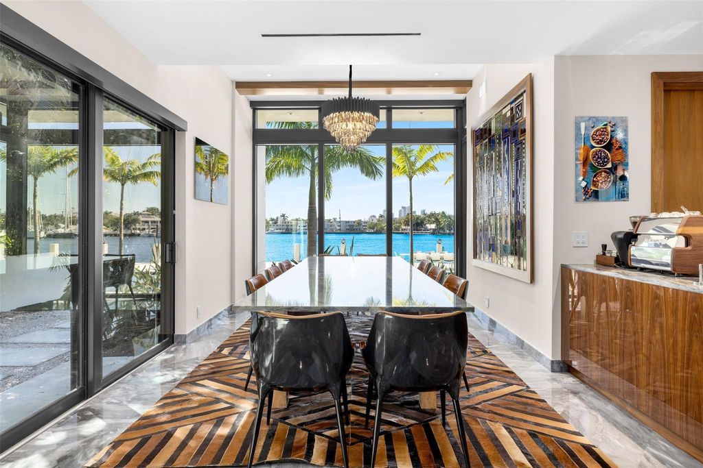 Rebuilt in July 2023, this single-story smart home offers 5,073 square feet of sophisticated living space on a sprawling 15,300-square-foot lot with a 2,300-square-foot dock adorned with coral stone from Spain.