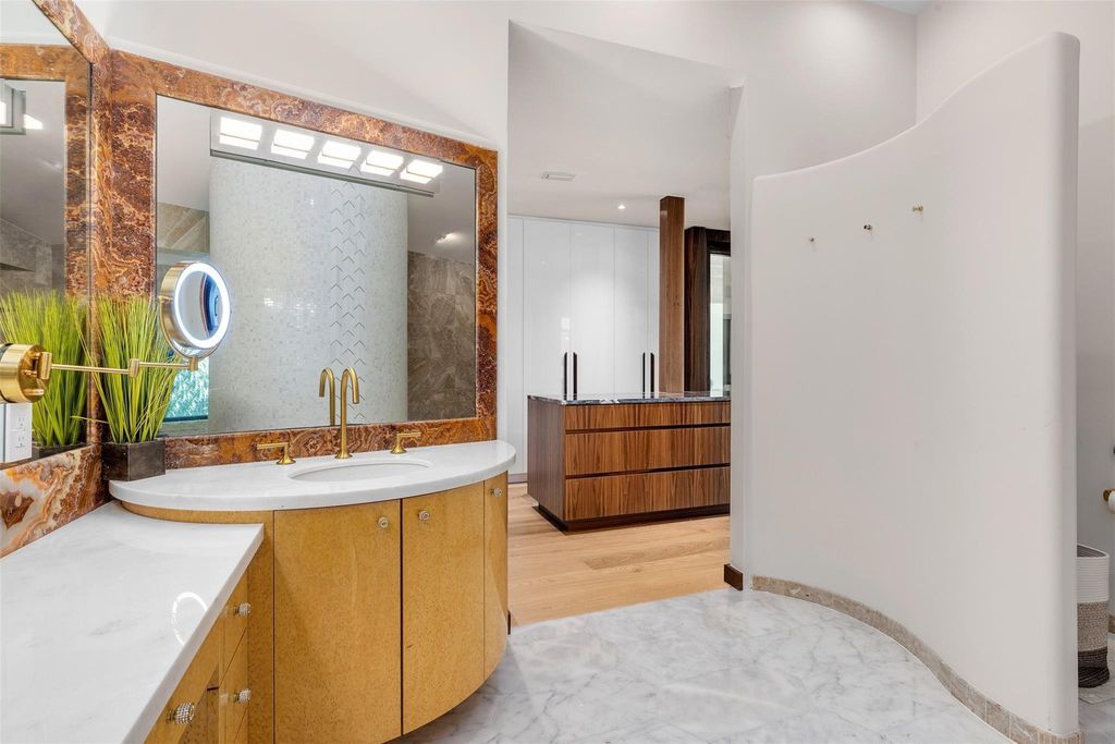 Rebuilt in July 2023, this single-story smart home offers 5,073 square feet of sophisticated living space on a sprawling 15,300-square-foot lot with a 2,300-square-foot dock adorned with coral stone from Spain.