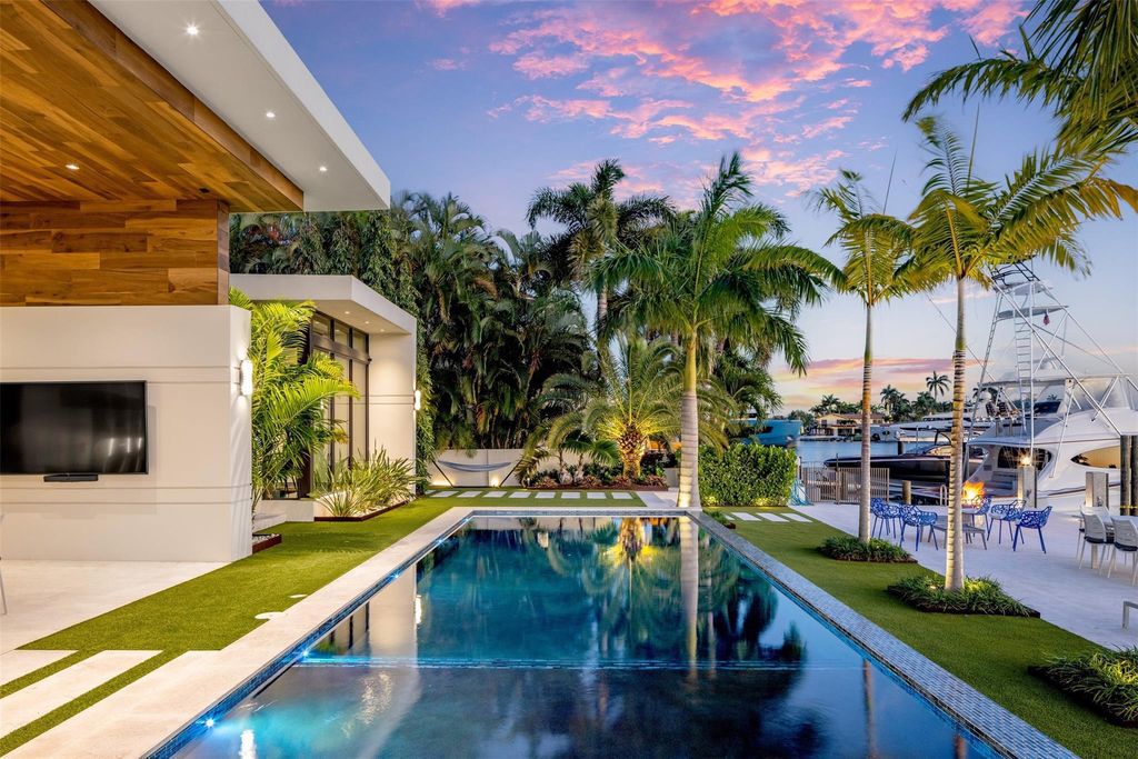 Rebuilt in July 2023, this single-story smart home offers 5,073 square feet of sophisticated living space on a sprawling 15,300-square-foot lot with a 2,300-square-foot dock adorned with coral stone from Spain.