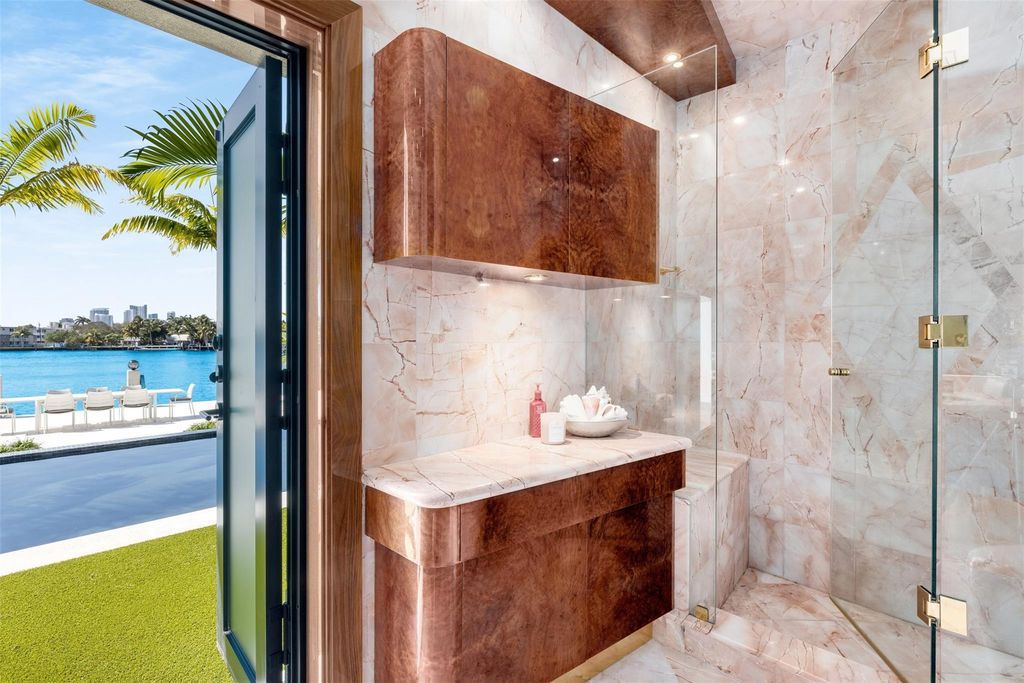 Rebuilt in July 2023, this single-story smart home offers 5,073 square feet of sophisticated living space on a sprawling 15,300-square-foot lot with a 2,300-square-foot dock adorned with coral stone from Spain.