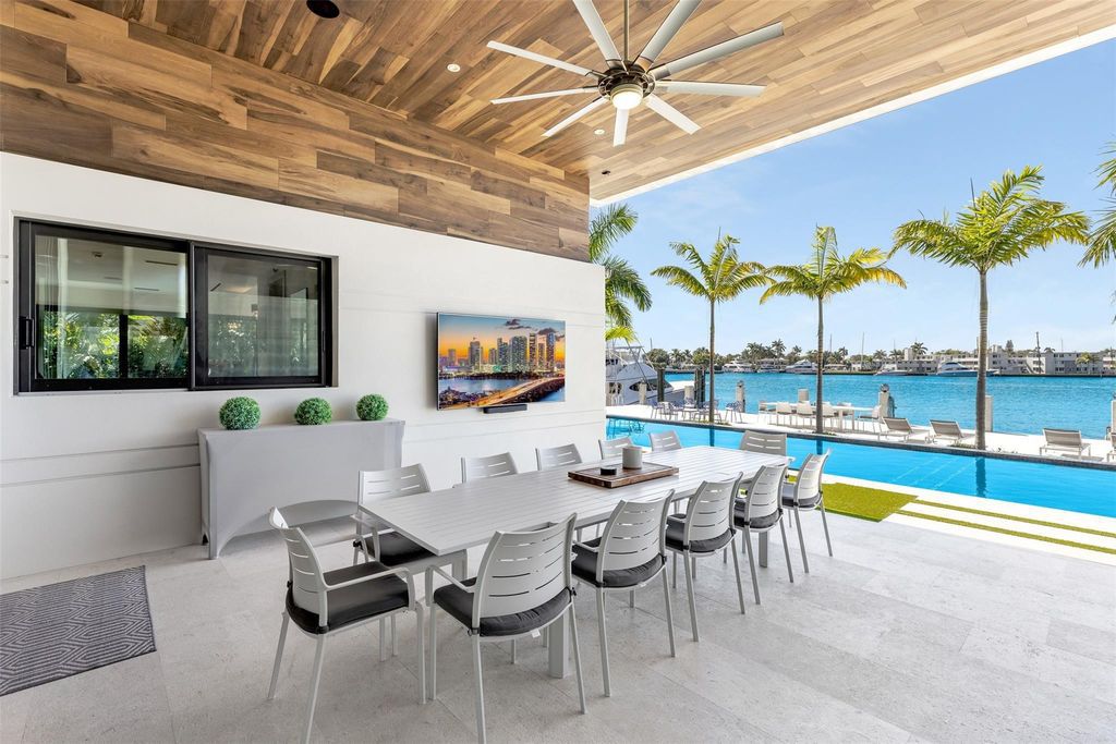 Rebuilt in July 2023, this single-story smart home offers 5,073 square feet of sophisticated living space on a sprawling 15,300-square-foot lot with a 2,300-square-foot dock adorned with coral stone from Spain.