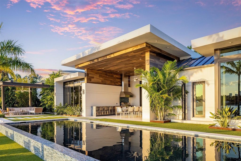 Rebuilt in July 2023, this single-story smart home offers 5,073 square feet of sophisticated living space on a sprawling 15,300-square-foot lot with a 2,300-square-foot dock adorned with coral stone from Spain.