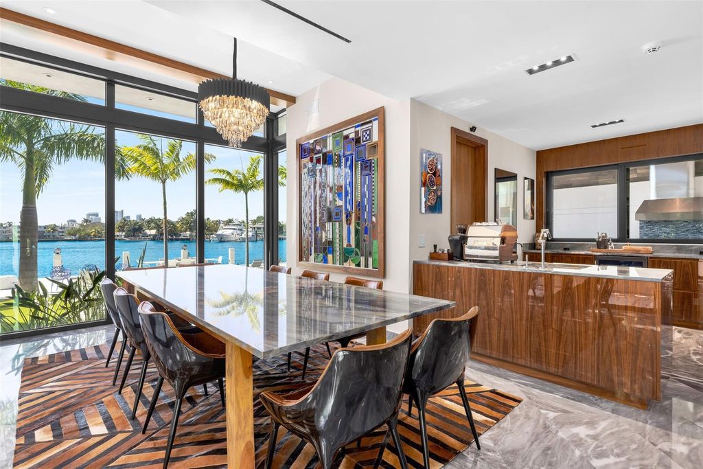 Rebuilt in July 2023, this single-story smart home offers 5,073 square feet of sophisticated living space on a sprawling 15,300-square-foot lot with a 2,300-square-foot dock adorned with coral stone from Spain.