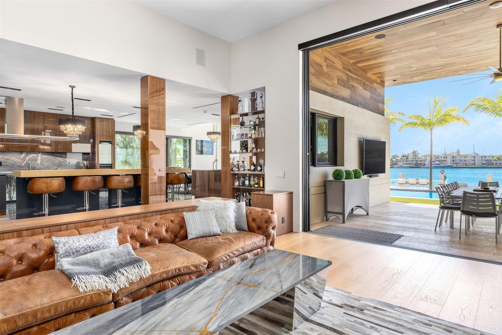 Rebuilt in July 2023, this single-story smart home offers 5,073 square feet of sophisticated living space on a sprawling 15,300-square-foot lot with a 2,300-square-foot dock adorned with coral stone from Spain.