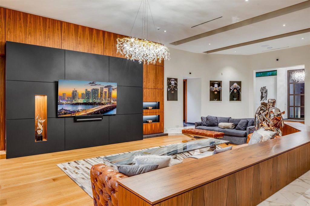 Rebuilt in July 2023, this single-story smart home offers 5,073 square feet of sophisticated living space on a sprawling 15,300-square-foot lot with a 2,300-square-foot dock adorned with coral stone from Spain.