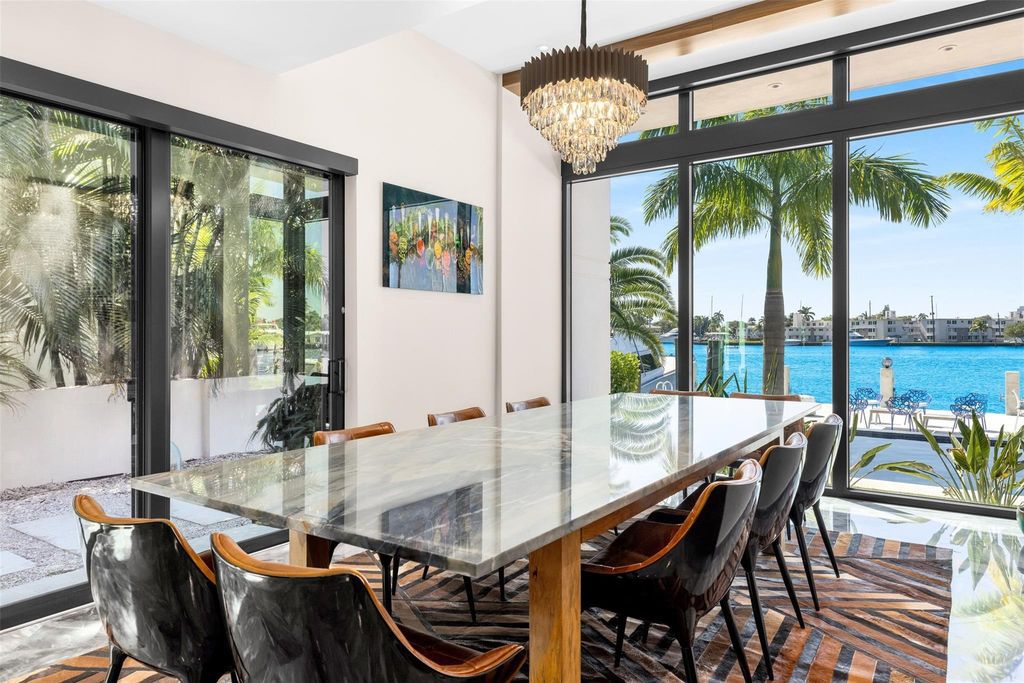Rebuilt in July 2023, this single-story smart home offers 5,073 square feet of sophisticated living space on a sprawling 15,300-square-foot lot with a 2,300-square-foot dock adorned with coral stone from Spain.