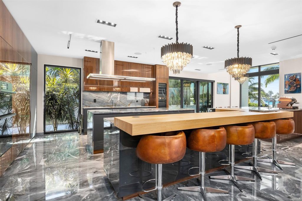 Rebuilt in July 2023, this single-story smart home offers 5,073 square feet of sophisticated living space on a sprawling 15,300-square-foot lot with a 2,300-square-foot dock adorned with coral stone from Spain.