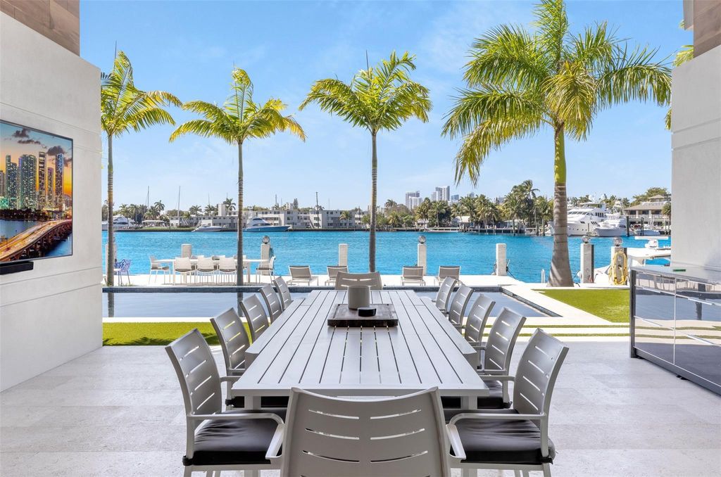 Rebuilt in July 2023, this single-story smart home offers 5,073 square feet of sophisticated living space on a sprawling 15,300-square-foot lot with a 2,300-square-foot dock adorned with coral stone from Spain.
