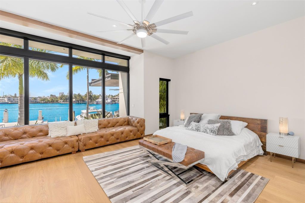 Rebuilt in July 2023, this single-story smart home offers 5,073 square feet of sophisticated living space on a sprawling 15,300-square-foot lot with a 2,300-square-foot dock adorned with coral stone from Spain.