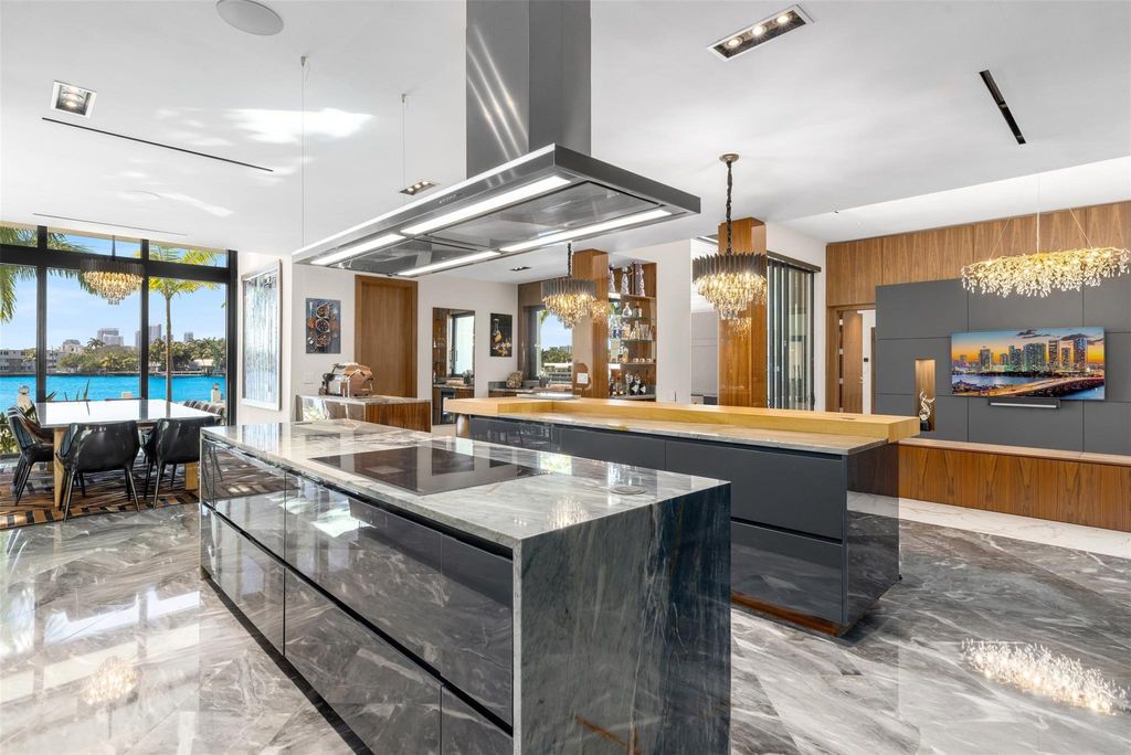 Rebuilt in July 2023, this single-story smart home offers 5,073 square feet of sophisticated living space on a sprawling 15,300-square-foot lot with a 2,300-square-foot dock adorned with coral stone from Spain.