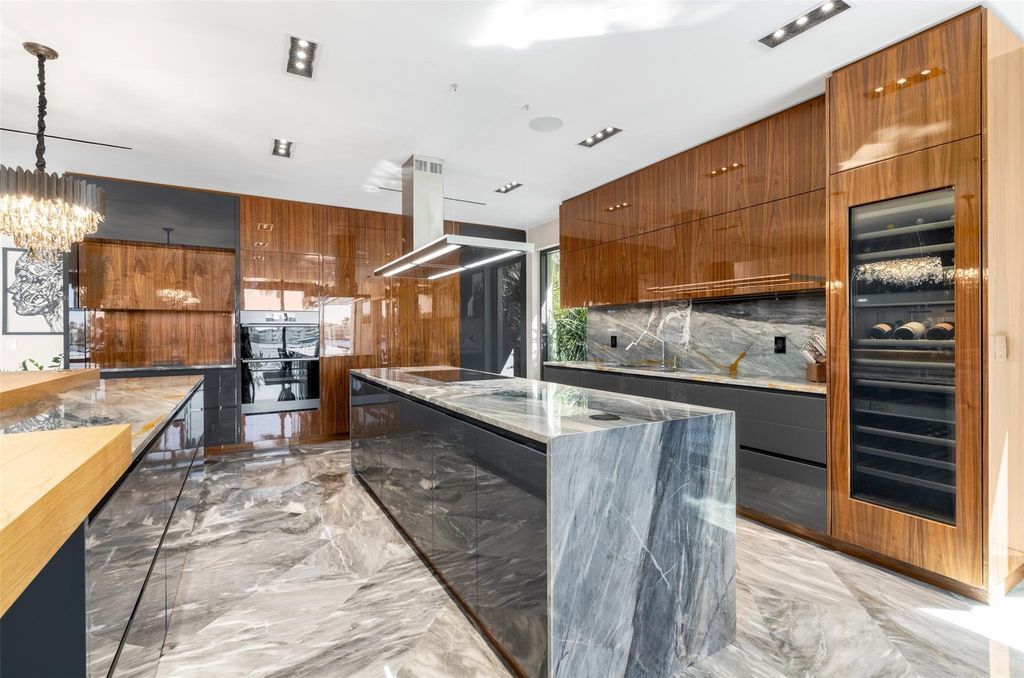 Rebuilt in July 2023, this single-story smart home offers 5,073 square feet of sophisticated living space on a sprawling 15,300-square-foot lot with a 2,300-square-foot dock adorned with coral stone from Spain.